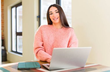 pretty young woman with a laptop on a desk  at home