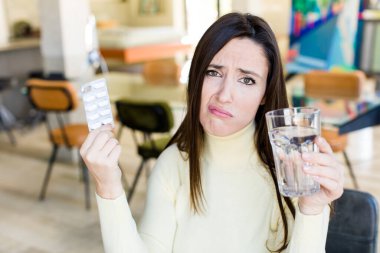 adult pretty woman with pills. flu concept