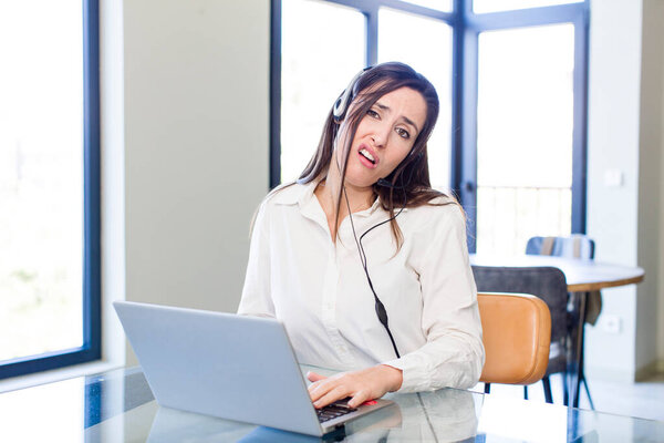 young pretty woman feeling puzzled and confused. telemarketer concept