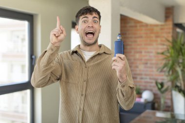 Genç yakışıklı bir adam bir fikri fark ettikten sonra mutlu ve heyecanlı bir dahi gibi hissediyor. Vaper sigara içme konsepti