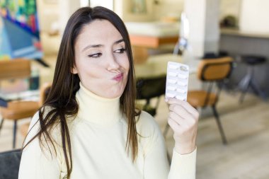 adult pretty woman with pills. flu concept