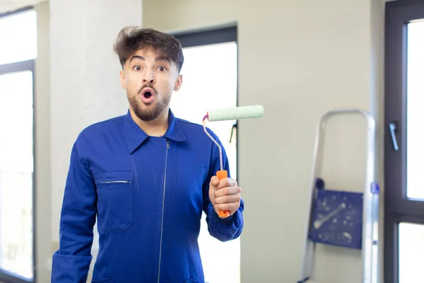 Young Handsome Man Feeling Extremely Shocked Surprised Painting Home Concept — Stock Photo, Image
