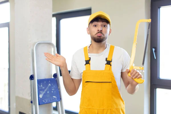 Young Handsome Man Shrugging Feeling Confused Uncertain Handyman Saw — Stock Photo, Image