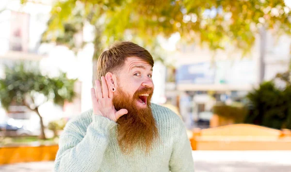 Red Hair Bearded Man Looking Happy Listening Trying Hear Secret — Stock Photo, Image
