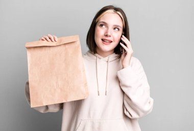 young pretty woman with a take away paper bag