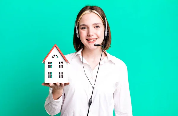 young pretty agent woman with a house model. real state concept