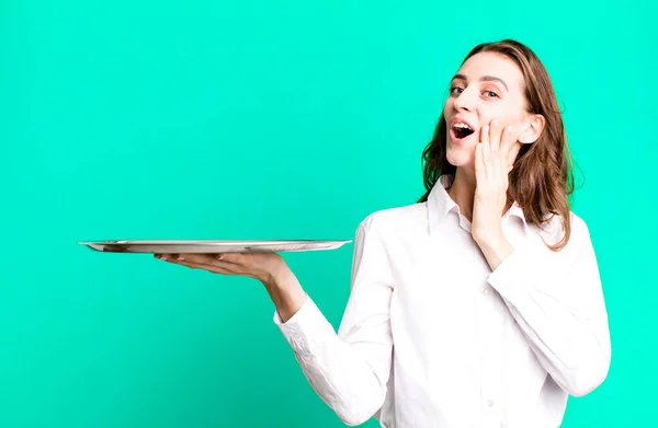 stock image young pretty woman holding an empty pray with a copy space