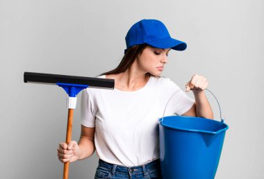 young pretty woman housekeeper cleaning the windows