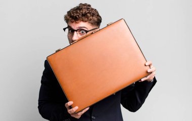 young adult caucasian businessman with a suit case