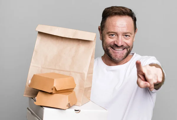 middle age man pointing at camera choosing you. delivery and fast food take away concept
