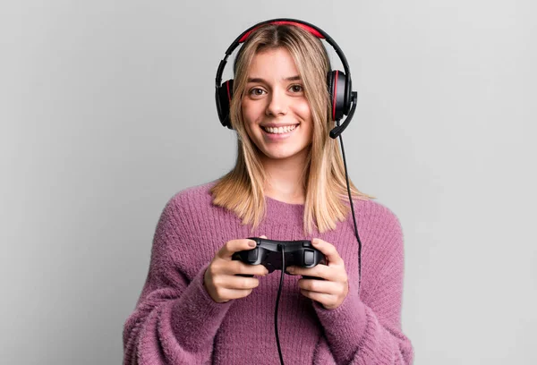 Stock image young pretty gamer woman with headset and a controller