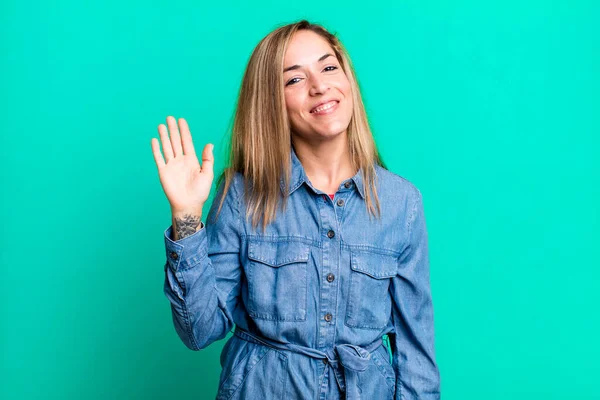 Blonde Adult Woman Smiling Happily Cheerfully Waving Hand Welcoming Greeting — Stock Photo, Image