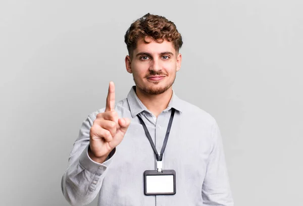 Young Adult Caucasian Man Smiling Looking Friendly Showing Number One — Stock Photo, Image