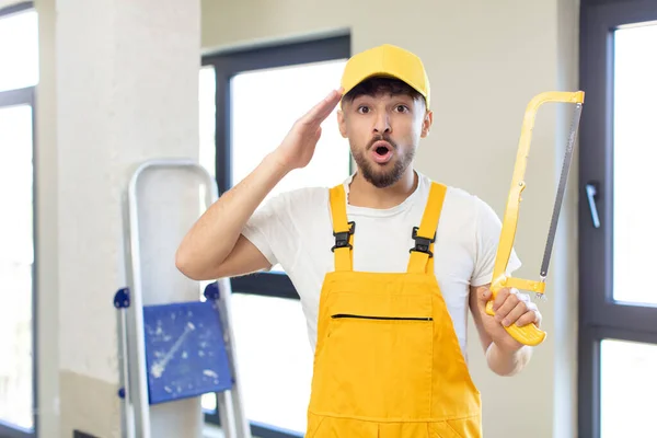 Young Handsome Man Looking Happy Astonished Surprised Handyman Saw — Stock Photo, Image