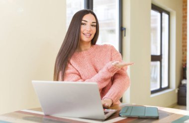 pretty young woman with a laptop on a desk  at home
