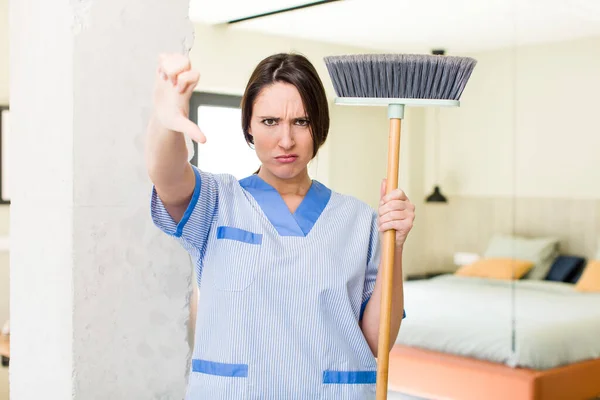 Young Pretty Woman Feeling Cross Showing Thumbs Housekeeper Concept — 图库照片