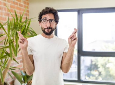 young adult crazy man with expressive pose at a modern house interior