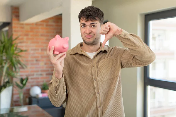 Young Handsome Man Feeling Cross Showing Thumbs Piggy Bank Concept — Stock Photo, Image