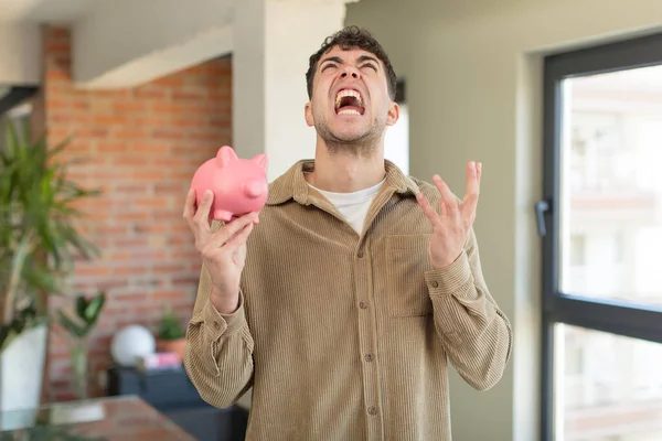 Young Handsome Man Screaming Hands Air Piggy Bank Concept — Stock Photo, Image