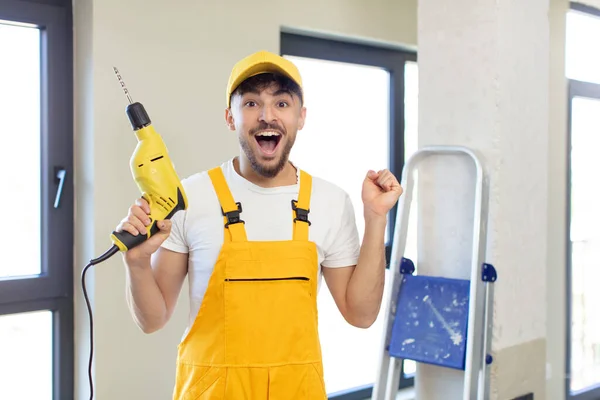 Young Handsome Man Feeling Shocked Laughing Celebrating Success Handyman Drill — Stock Photo, Image