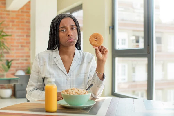 black afro woman feeling sad and whiney with an unhappy look and crying. breakfast concept