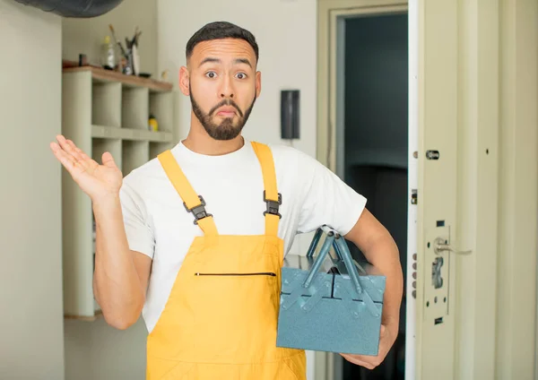 Young Adult Man Shrugging Feeling Confused Uncertain Handyman Concept — Stock Photo, Image