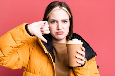 young pretty woman with a coat and a take away coffee