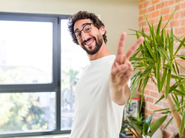 young adult crazy man with expressive pose at a modern house interior