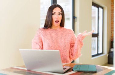 pretty young woman with a laptop on a desk  at home