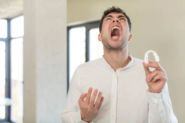 Young Handsome Man Screaming Hands Air Dental Retainer Concept — Stock Photo, Image