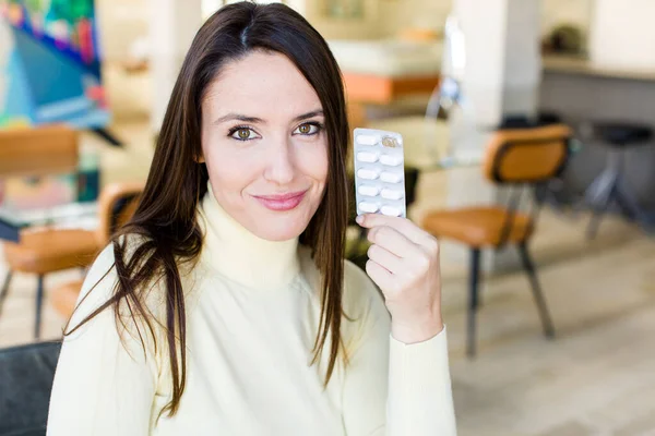 stock image adult pretty woman with pills. flu concept