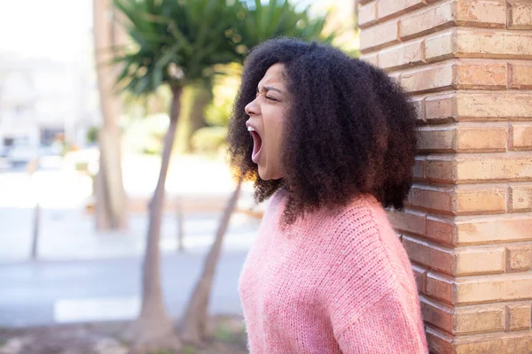 stock image african american pretty woman shouting aggressively, looking very angry, frustrated, outraged or annoyed, screaming no