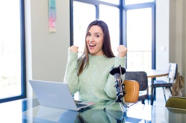 young pretty woman feeling shocked,laughing and celebrating success. influencer concept