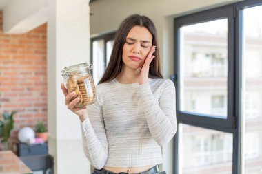 Sıkılmış, hayal kırıklığına uğramış ve yorgun hisseden genç bir manken. Ev yapımı kurabiye konsepti