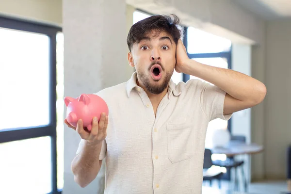 Young Handsome Man Feeling Extremely Shocked Surprised Piggy Bank Concept — Stock Photo, Image