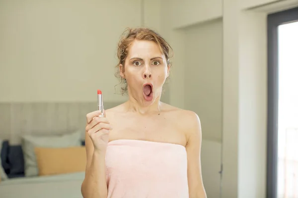 stock image young pretty woman feeling extremely shocked and surprised. lipstick concept