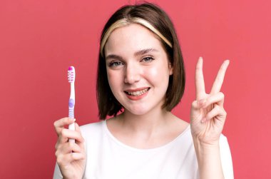 young pretty woman using a toothbrush
