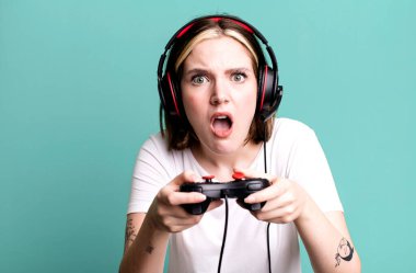 young pretty woman with headset and a controller. gamer concept