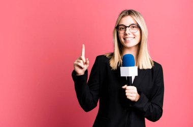 young pretty journalist or presenter woman with a microphone