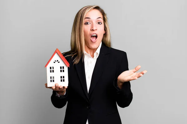 Pretty Blonde Woman Feeling Extremely Shocked Surprised Real State Concept — Stockfoto