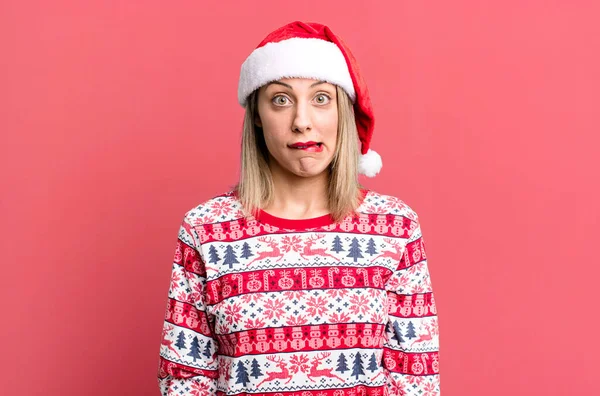 Pretty Blonde Woman Looking Puzzled Confused Christmas Santa Hat Concept — Stockfoto