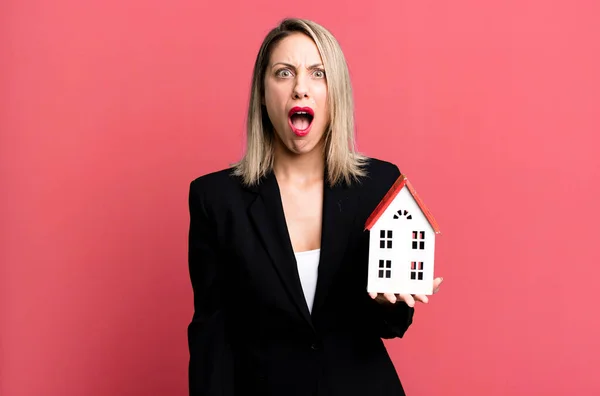 Pretty Blonde Woman Looking Very Shocked Surprised Real State Concept — Stockfoto