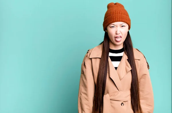 stock image pretty asian woman feeling disgusted and irritated and tongue out