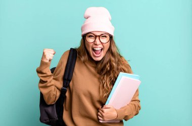 hispanic pretty woman shouting aggressively with an angry expression. university student concept