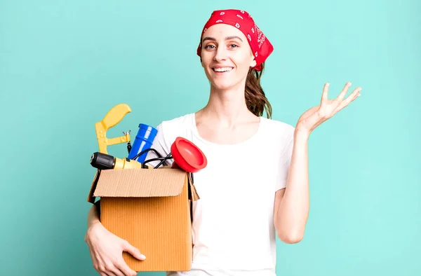 stock image young pretty woman feeling happy, surprised realizing a solution or idea. housekeeper and toolbox concept