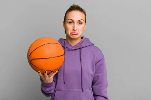 young pretty woman feeling sad and whiney with an unhappy look and crying. basketball concept