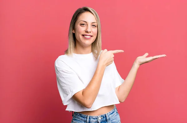 Blonde Adult Woman Smiling Cheerfully Pointing Copy Space Palm Side — Stock fotografie