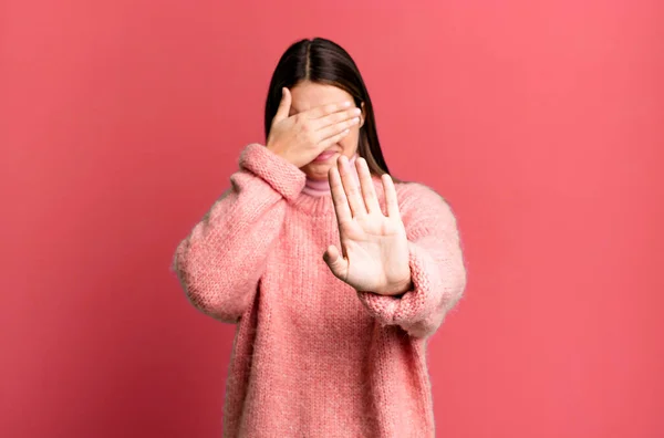 Pretty Young Adult Woman Covering Face Hand Putting Other Hand — Stok fotoğraf