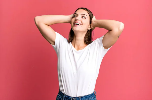 stock image pretty young adult woman smiling and feeling relaxed, satisfied and carefree, laughing positively and chilling