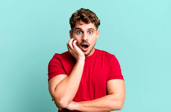 Young Adult Caucasian Man Open Mouthed Shock Disbelief Hand Cheek — Stockfoto